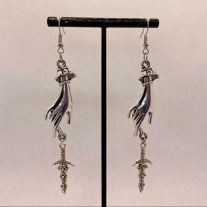 Victorian hand with ornate dagger earrings silver tone